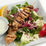 Savor Greek Chicken Kebabs Drizzled with Creamy Tzatziki