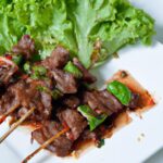 Savor Grilled Beef Skewers with Zesty Spicy Jaew Sauce